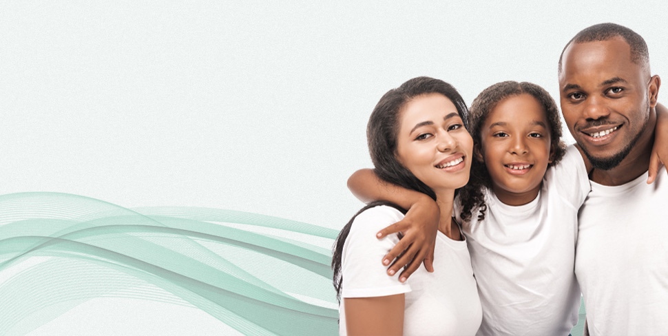 Man and woman with their daughter smiling with bright white teeth